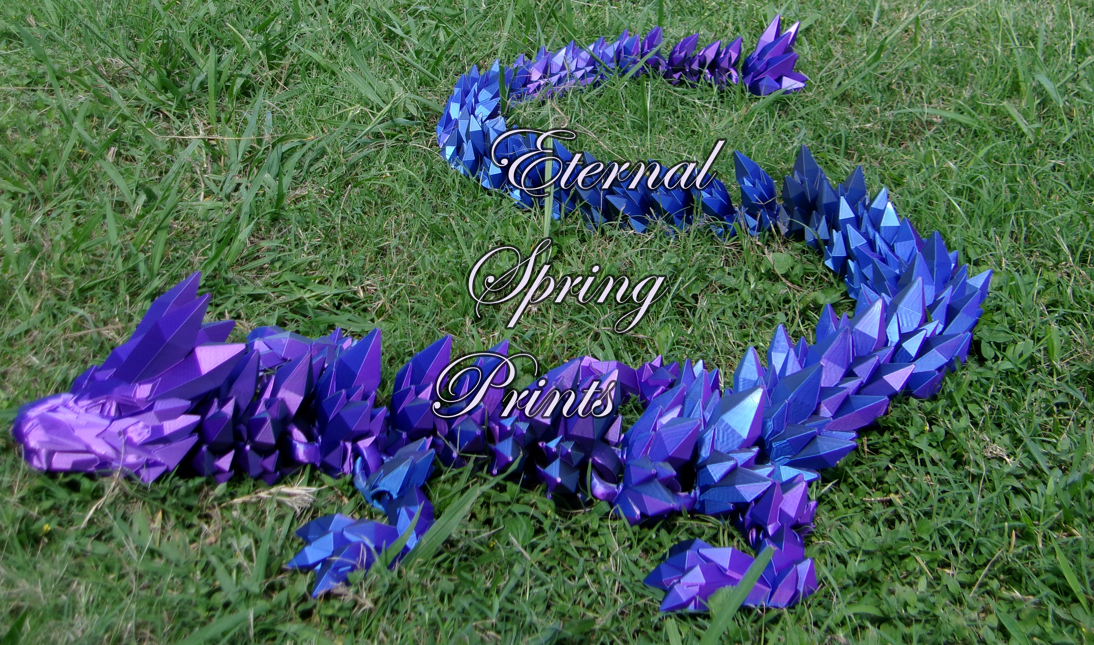 Purple and blue dragon sculpture on grass with 'Eternal Spring Prints' text.